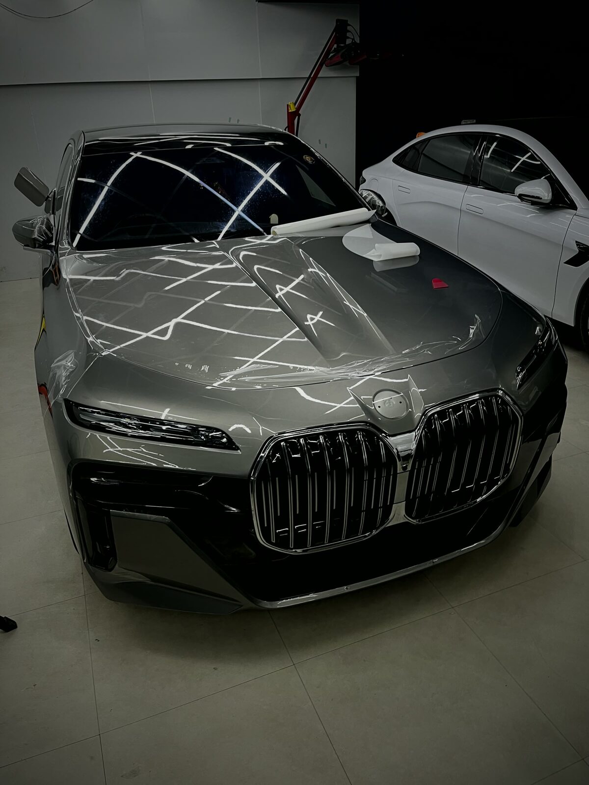 Paint protection film being applied to a BMW